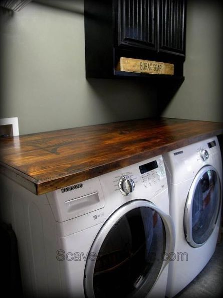 a washer and dryer sitting next to each other on top of a counter