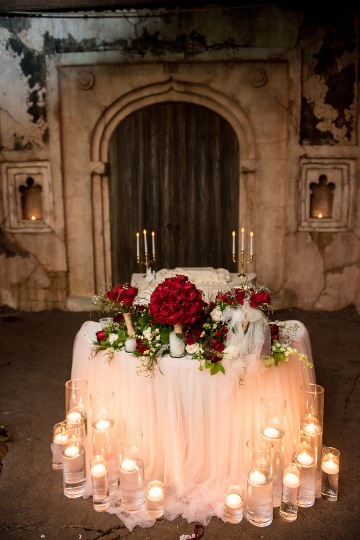 a table with candles and flowers on it