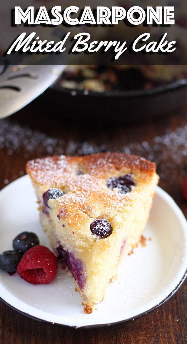 a close up of a piece of cake on a plate with berries and raspberries