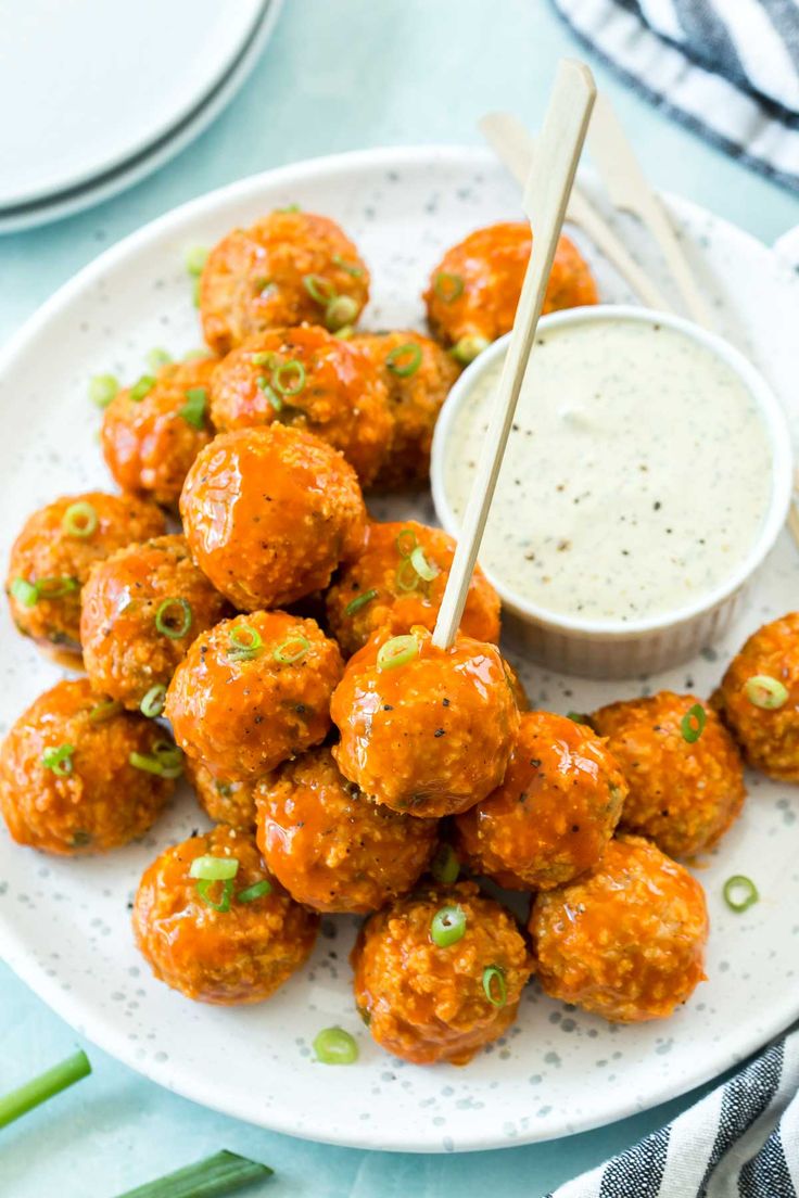 buffalo chicken meatballs on a plate with dipping sauce