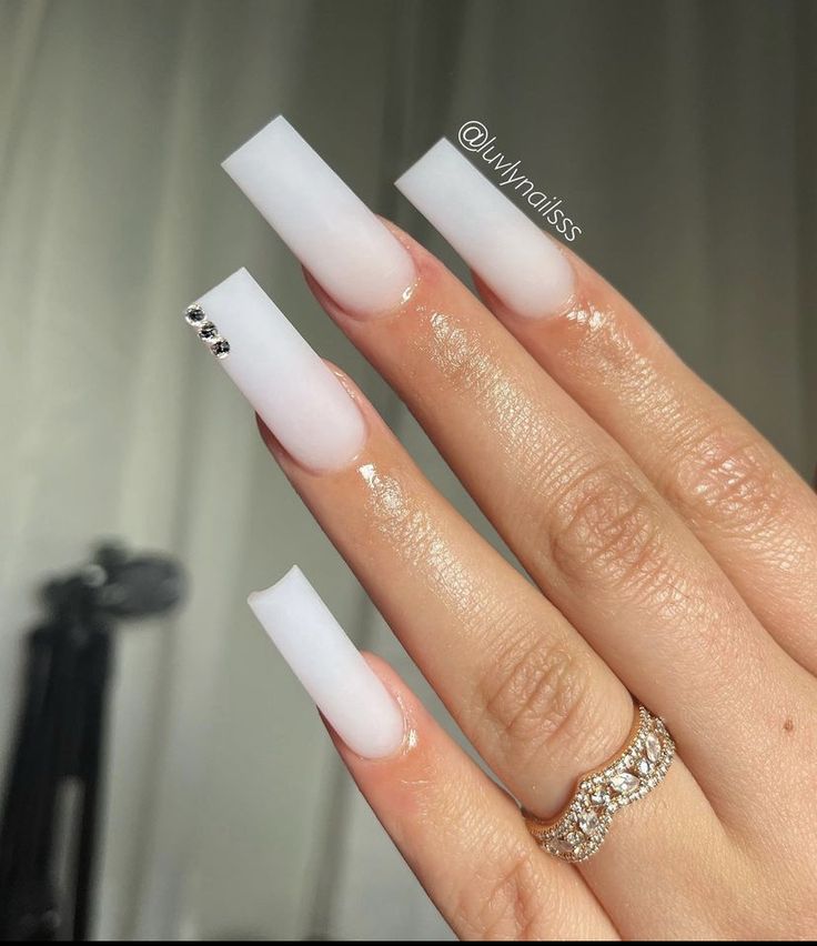 White Acrylic With Rhinestones, White On White Acrylic Nails, Plain White Nails With Rhinestones, All White Nail Designs, Small Rhinestone Nails Designs, White Medium Length Nails, White Matte Nails With Design, Soft White Nails Acrylic With Design, All White Nails Acrylic