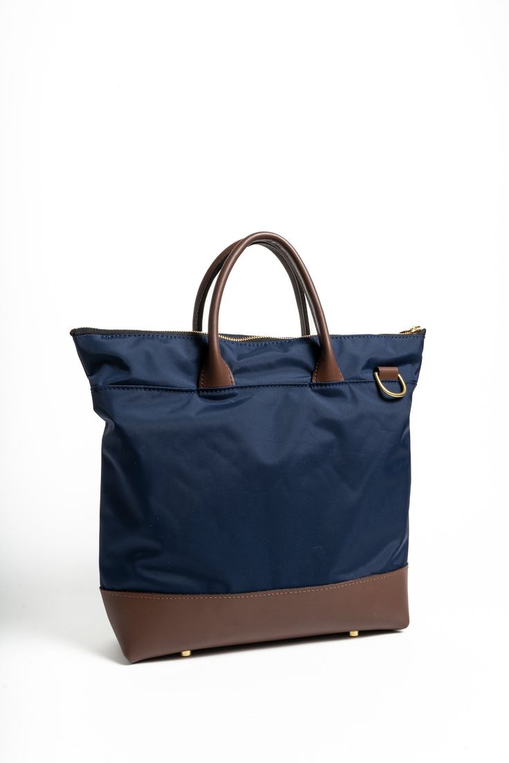 The medium tote is the quintessential companion for the woman on the go. Balancing size and functionality, it offers ample space for your daily essentials without overwhelming your frame. Perfect for work, a day out, or a casual weekend trip, this tote combines style with practicality. The Otto medium tote is the quintessence of where elegance meets ethical fashion, offering the modern woman a way to look good, feel good, and do good simultaneously. Its sleek, versatile design is the perfect bal Modern Nylon Satchel For On-the-go, Nylon Satchel Tote For On-the-go, Everyday Nylon Top Handle Bag, Top Handle Nylon Bag For Everyday, Nylon Bags With Detachable Handle For On-the-go, Everyday Nylon Shoulder Bag With Leather Trim, Everyday Nylon Satchel With Double Handle, Nylon Bags With Detachable Handle, Travel Bag With Detachable Handle In Nylon