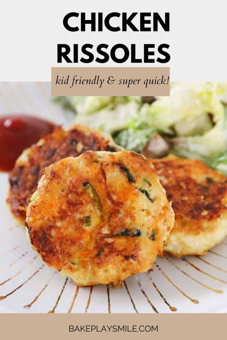 two crab cakes on a white plate with lettuce and ketchup in the background