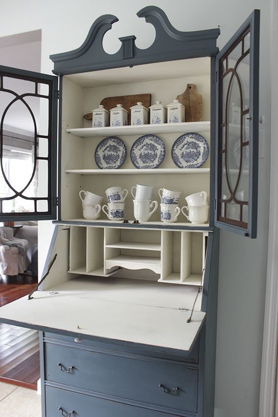 an old china cabinet is painted blue and white