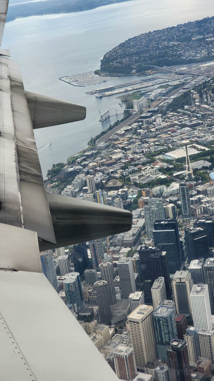 the wing of an airplane flying over a city