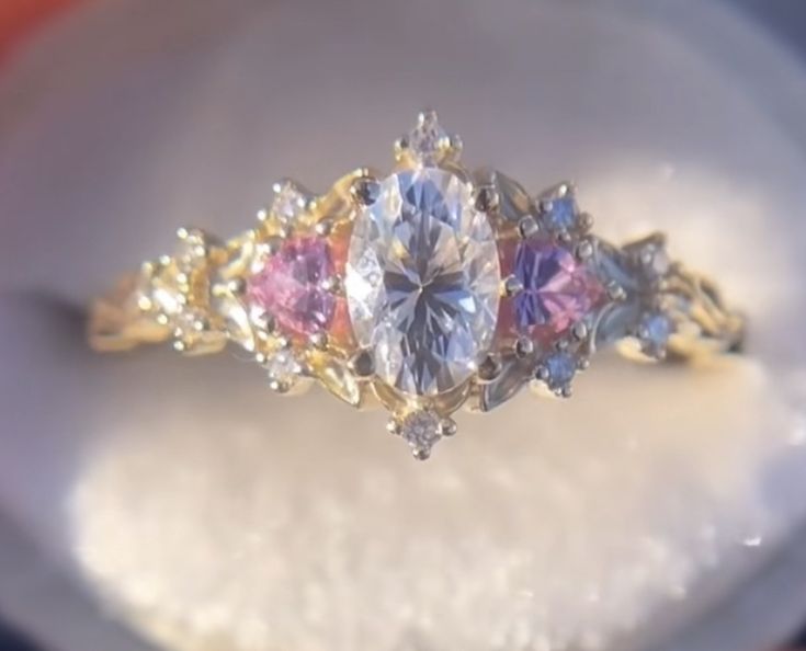 an engagement ring with three different colored stones