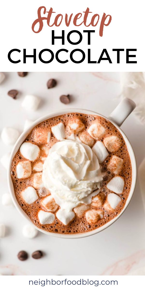 hot chocolate with marshmallows and whipped cream in a white cup on top