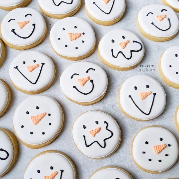 decorated cookies are arranged in the shape of snowmen