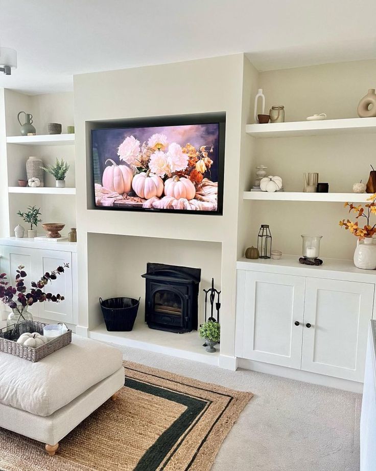 a living room filled with furniture and a flat screen tv mounted on the wall above a fireplace