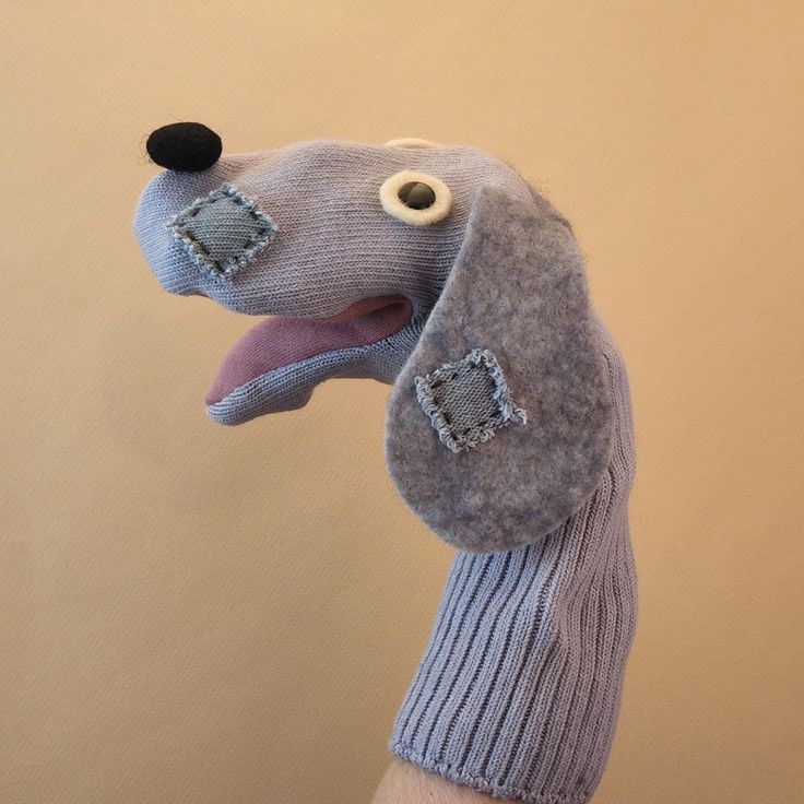 a stuffed dog wearing a sweater and hat