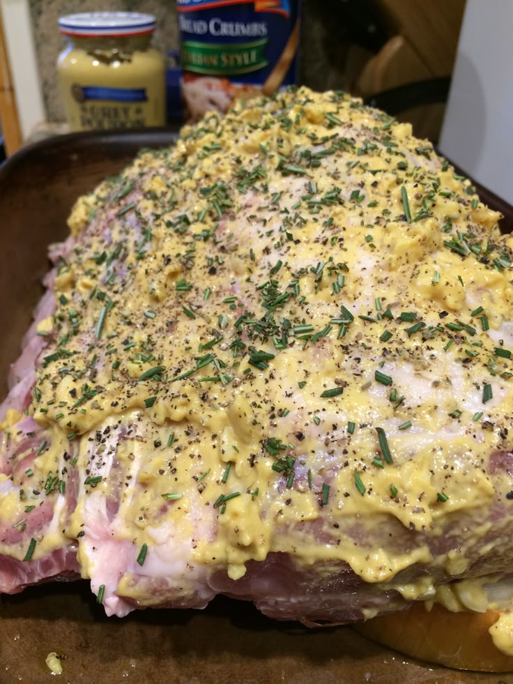 a large piece of meat covered in cheese and herbs