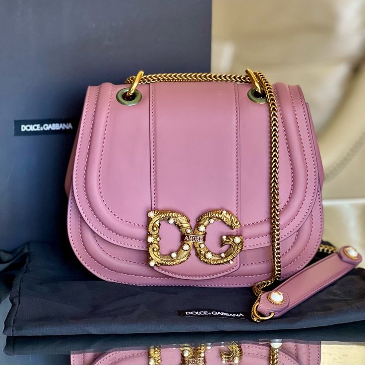 Dolce & Gabbana Amore Bag - New With Box, Authenticity Card, Dust Bag And Protective Foil - Color: Pink Powder - Size: 9”L X 7.1”H X 3.1”W - Shoulder Chain Strap Drop: 21” - Amore D&G Buckle At Front - Push Lock Closure - Internal Pocket With Zipper - Calf Leather - Can Be Worn Long, Short Or Cross Body Reasonable Offers Only Please! Dolce And Gabbana Pink Bag, Luxury Shoulder Bag With Dust Bag For Gift, High-end Pink Shoulder Bag For Evening, Luxury Shoulder Bag With Detachable Strap As Gift, Luxury Pink Shoulder Bag For Evening, Luxury Pink Bags As Gifts, Luxury Pink Bags For Gifts, Designer Pink Shoulder Bag For Evening, Pink Dolce And Gabbana