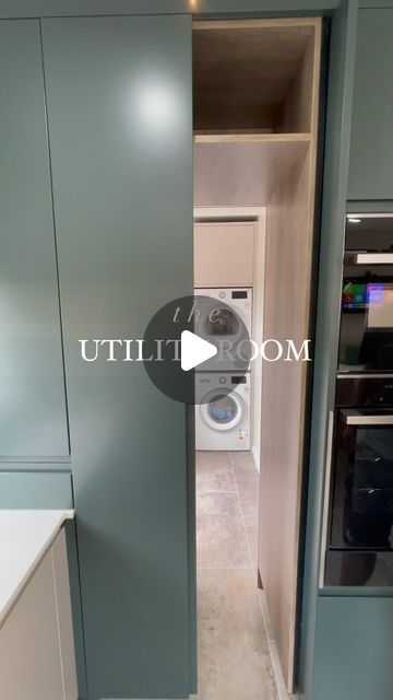 an open door leading to a washer and dryer in a room with blue walls