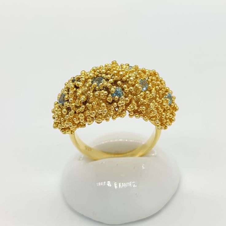 24K Gold Vermeil Handmade Ring with Blue Topaz and Granule Detailing - Artisan Crafted Statement Jewelry Embrace the allure of elegant design with our Handcrafted 24K Gold Vermeil Ring, studded with a captivating Natural Blue Topaz and embellished with granule detailing. A perfect blend of classic artistry and modern style, this piece is sure to add a touch of luxury to any ensemble. Each ring is meticulously crafted by hand, ensuring a level of detail and quality that is truly unique. The radia Gold Topaz Ring With Accent Stones, Gold Aquamarine Diamond Ring, Gold Aquamarine Diamond Ring With Gemstones, Gold Fusion Rings With Stones, Gold Diamond Ring With Aquamarine, Gold Topaz Crystal Ring With Accent Stones, Fine Jewelry Gold Diamond Ring With Blue Topaz, Gold Crystal Ring With Topaz Birthstone, Gold Topaz Ring With Accent Stones For Gift