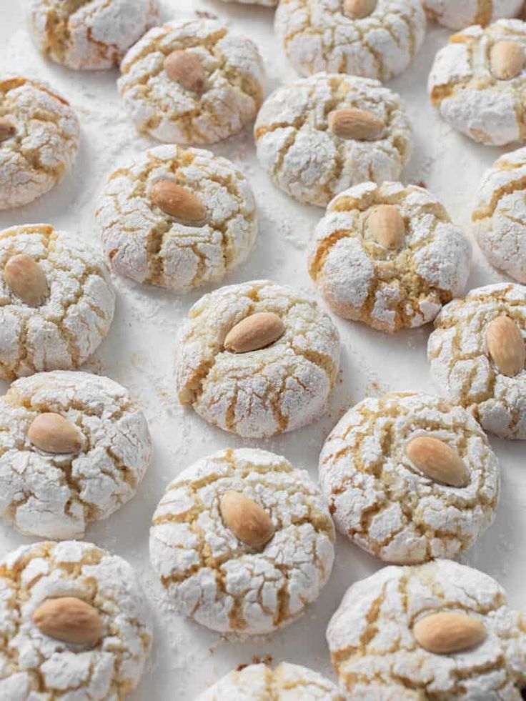 almond and powdered sugar cookies on a baking sheet