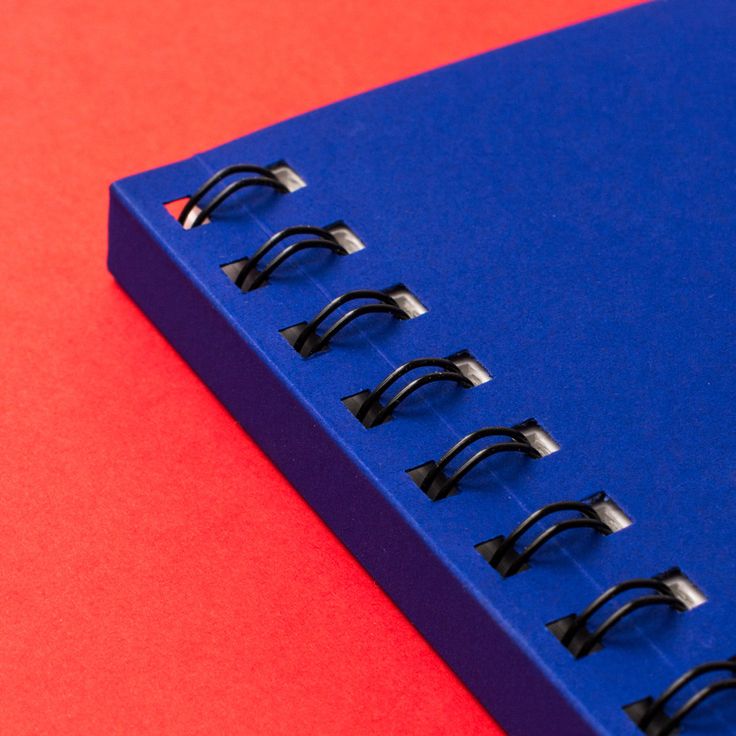 a blue notebook sitting on top of a red table