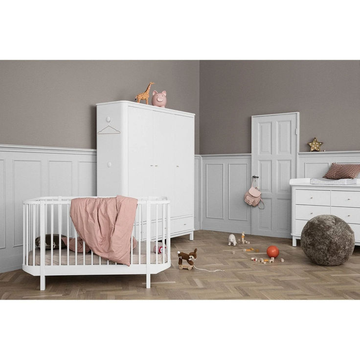 a baby's room with white furniture and accessories