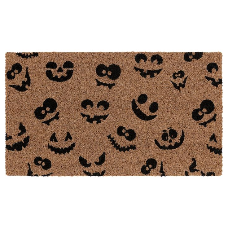 a door mat with halloween faces on it