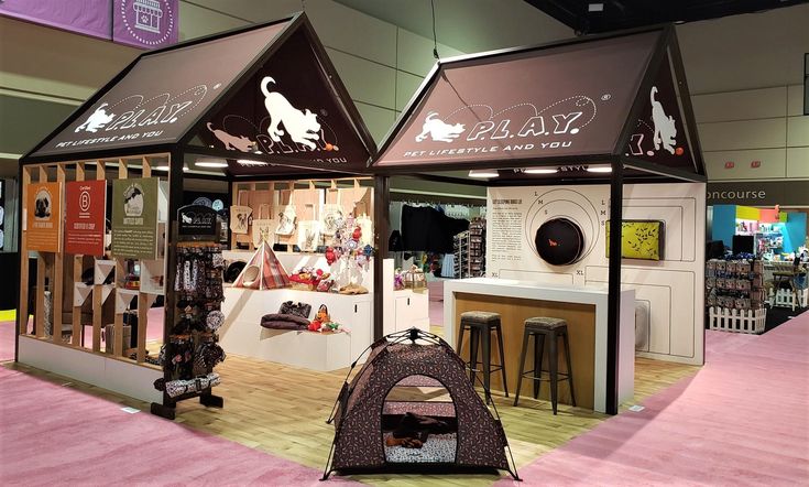 a dog store with two dogs in it's stalls and a cat bed on the floor