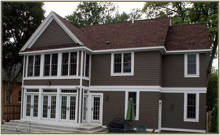 a brown house with white trim and windows