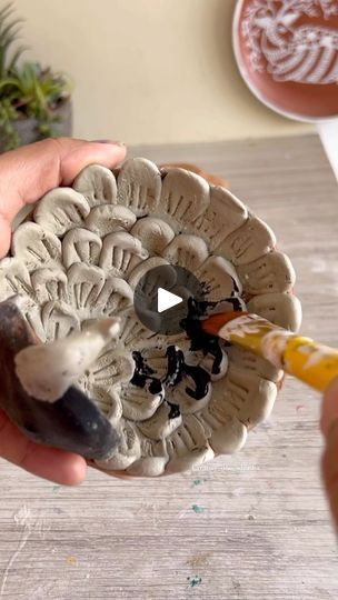 a person is holding a piece of art that looks like a mushroom with an opening in the middle