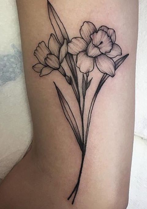 a black and white flower tattoo on the leg