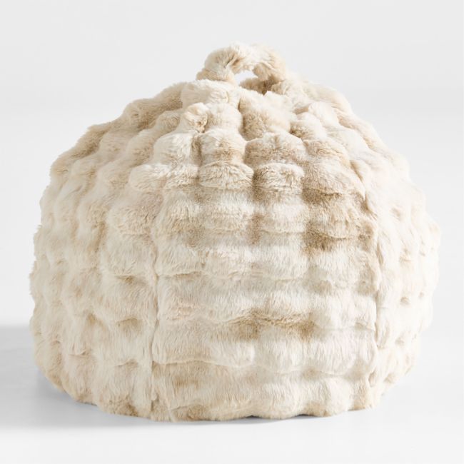 a white sheepskin bean bag sitting on top of a table