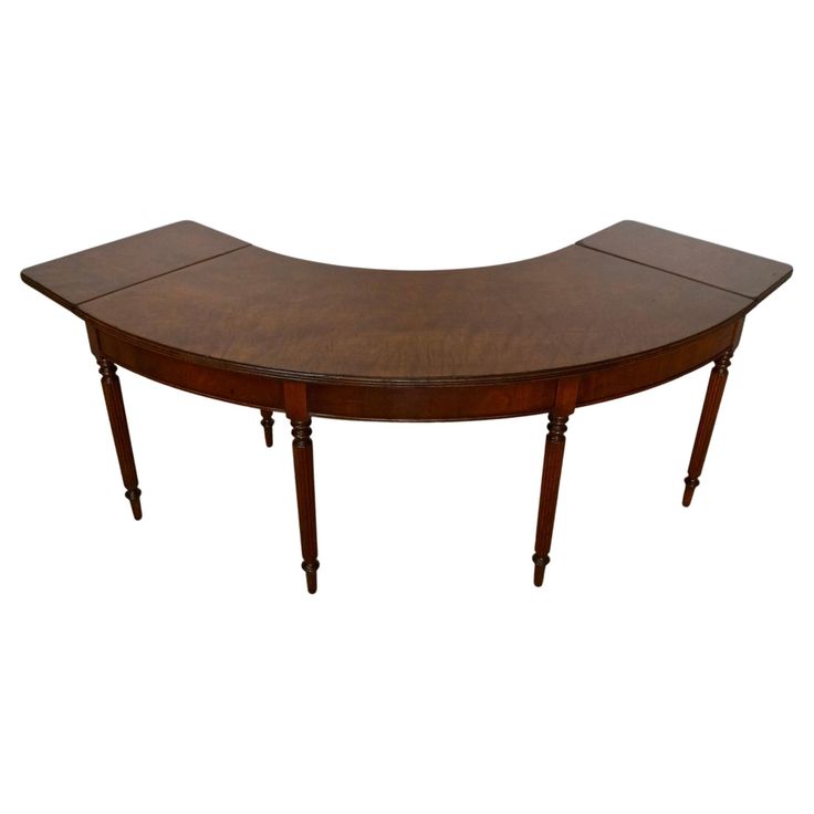 an oval wooden table with two legs and a curved top on one end, against a white background