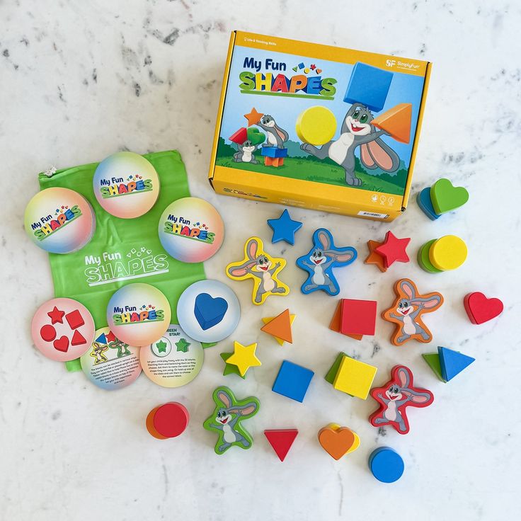 an assortment of magnets and toys on a marble surface