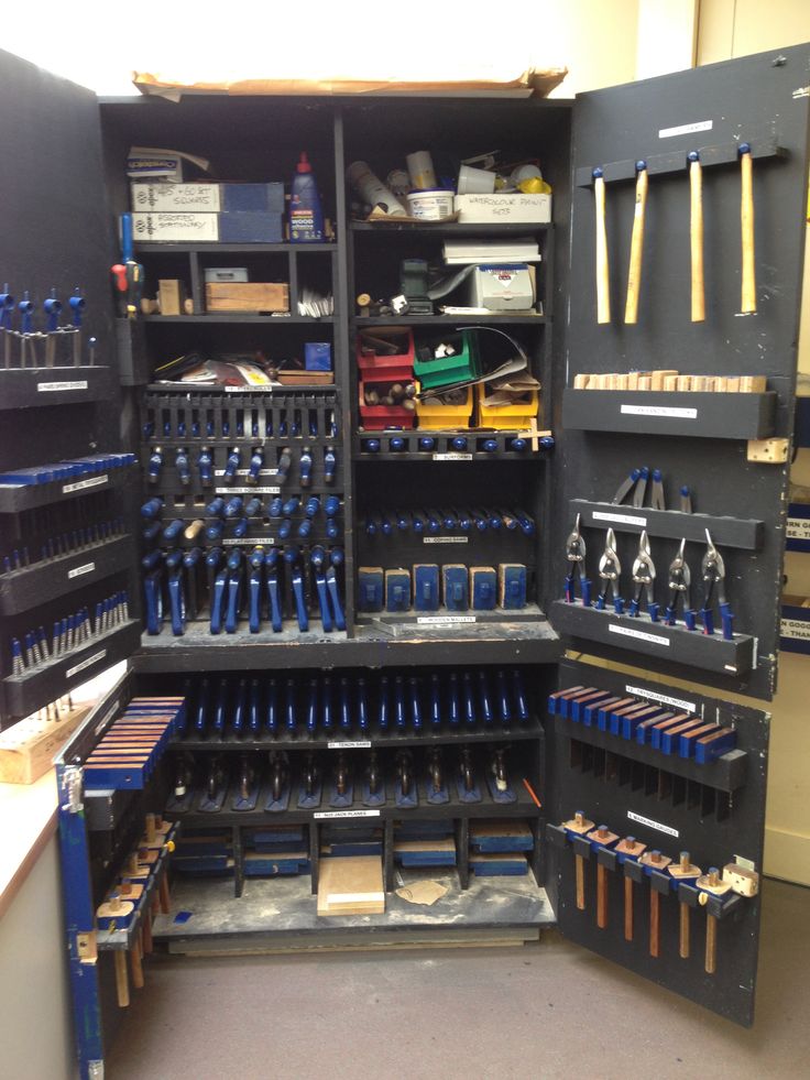 an open tool cabinet filled with lots of tools