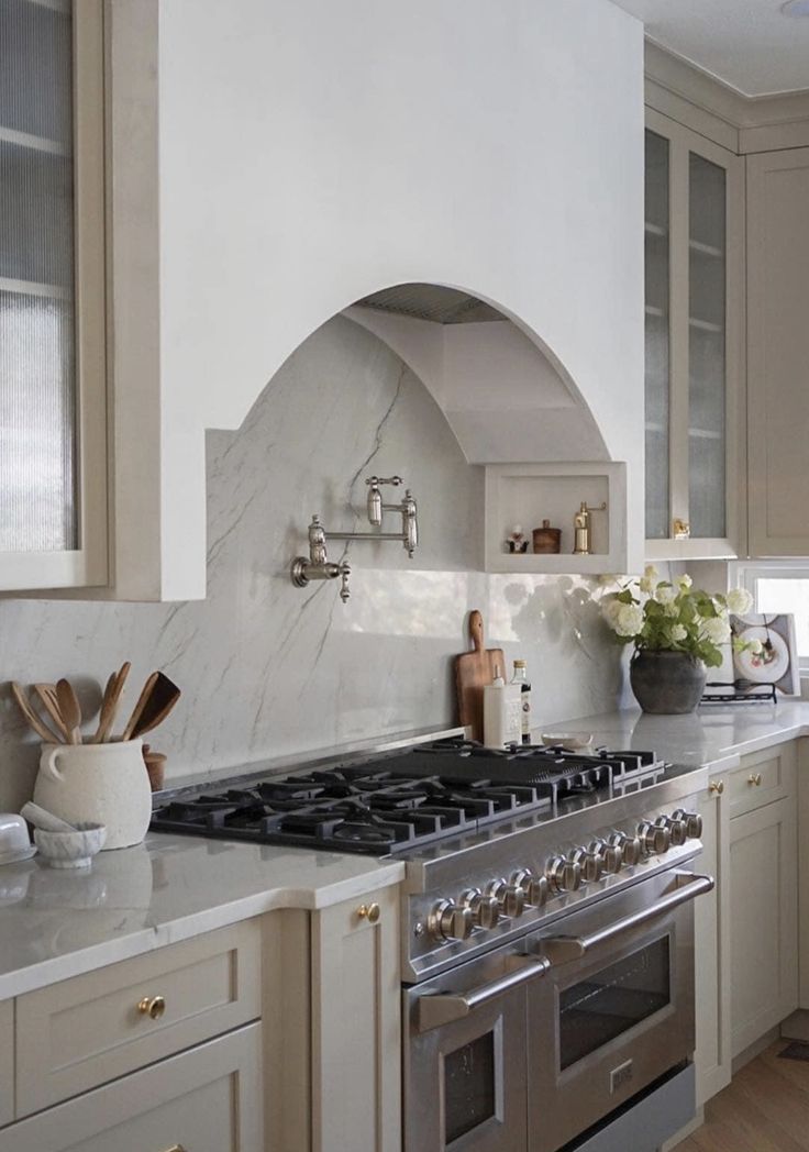 a stove top oven sitting inside of a kitchen next to a sink and counter tops