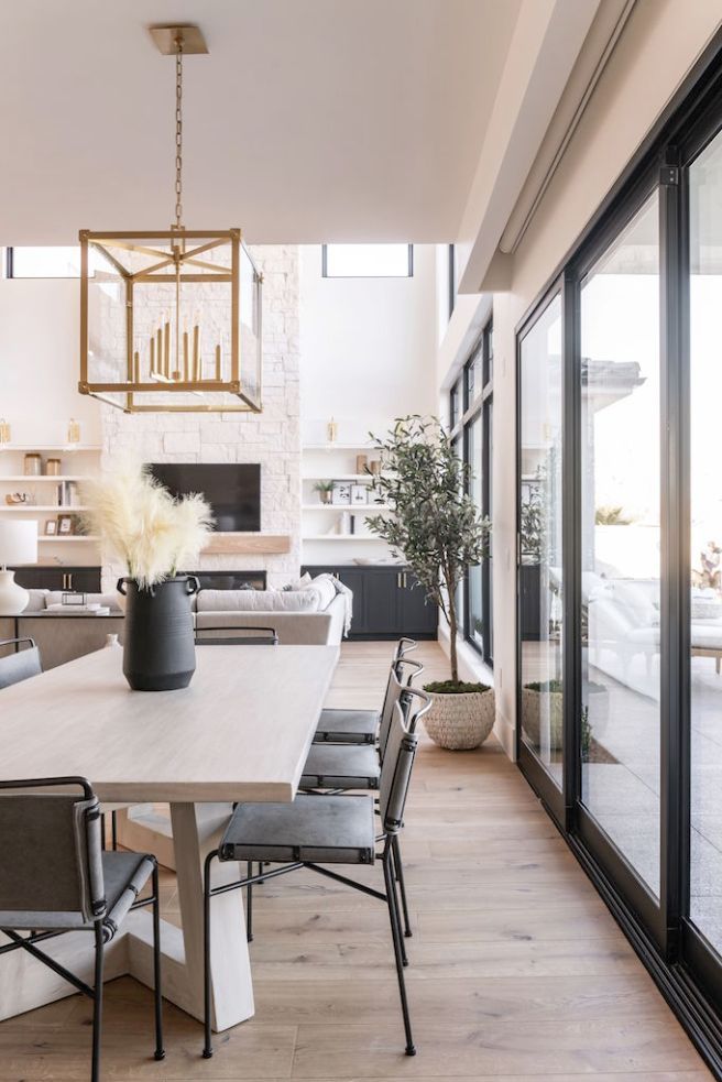 the dining room table is surrounded by black chairs