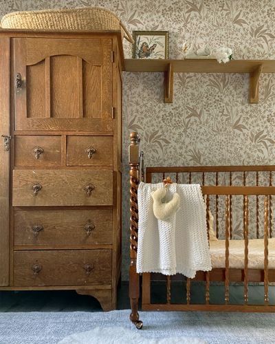 a baby's crib next to a wooden dresser