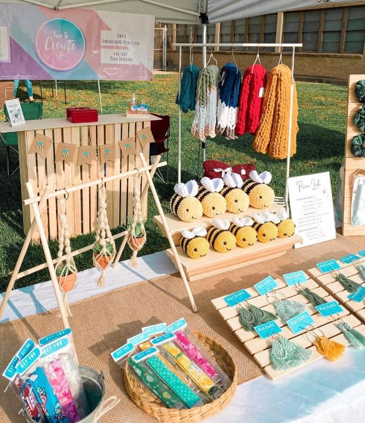 the table is set up with items for sale at the market stall, including yarn and buttons