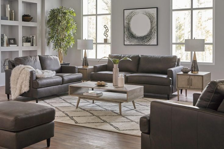 the living room is clean and ready to be used as a family room area with couches, loveseat, chair, coffee table and ottoman