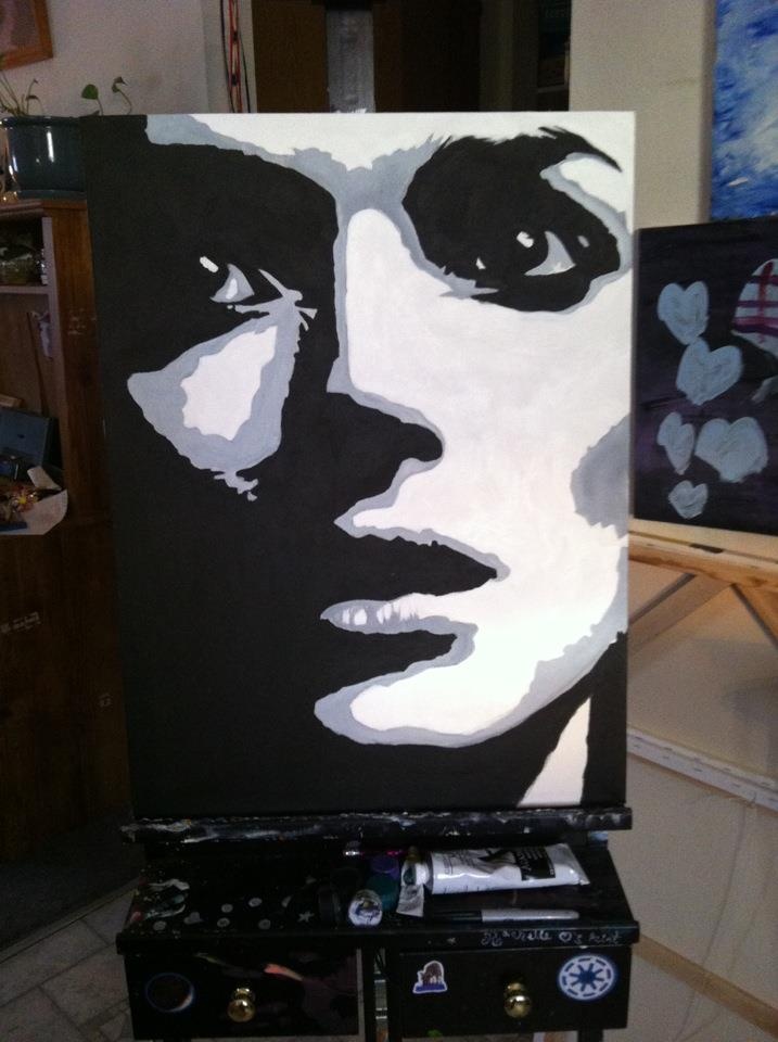 a woman's face is painted on a black and white canvas