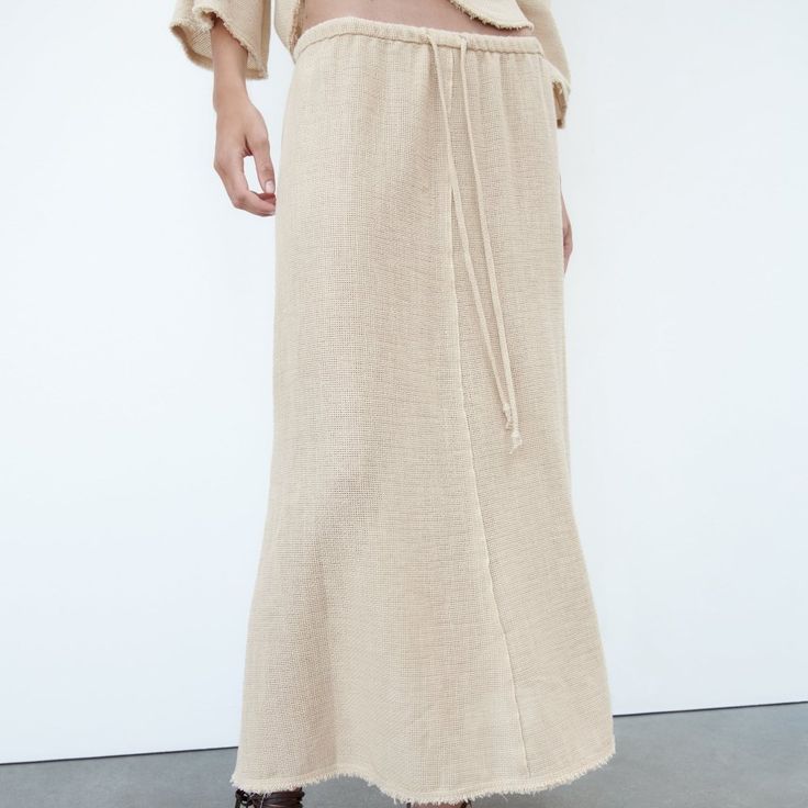 Midi Skirt With A Mid Waist Made Of Cotton And 7% Linen Blend Fabric. Adjustable Drawstring Waist. Frayed Trim. A-Line Silhouette. New Without Tags, Size Xs. Waist - Flat Lay 14.5 (Elastic, Tie, With Stretch) Length: 34 Inches Beige Tiered Lined Skirt, Relaxed Neutral Maxi Skirt, Beige Long Maxi Skirt For Vacation, Neutral Flowy Lined Skirt, Beige Relaxed Maxi Skirt For Summer, Neutral Midi Skirt With Lined Detail, Neutral Midi Skirt With Lining, Chic Long Skirt In Neutral Color, Beige Midi Skirt For Summer