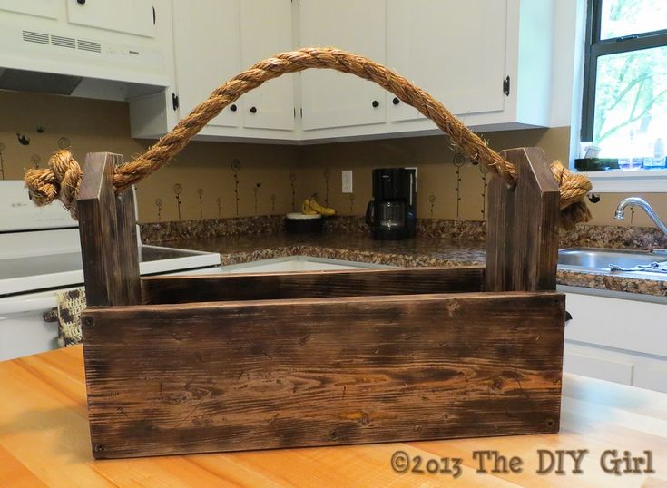 a wooden basket sitting on top of a kitchen counter