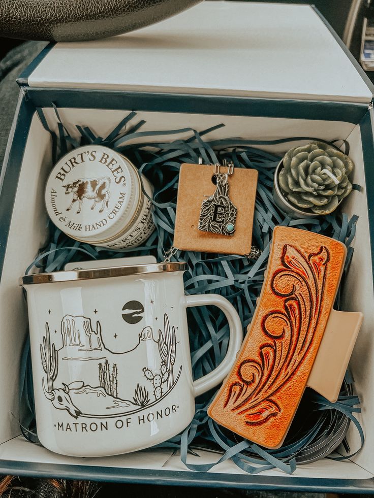 an assortment of items in a box including a coffee mug, soap and other things