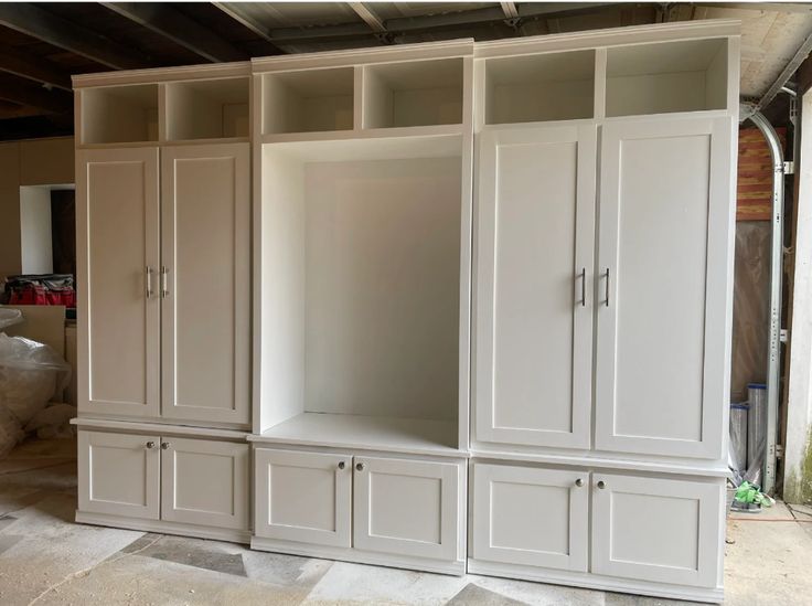 an empty room with some white cabinets in it