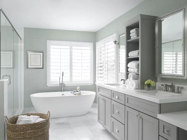 a bathroom with a tub, sink and mirror in the middle is featured on this page