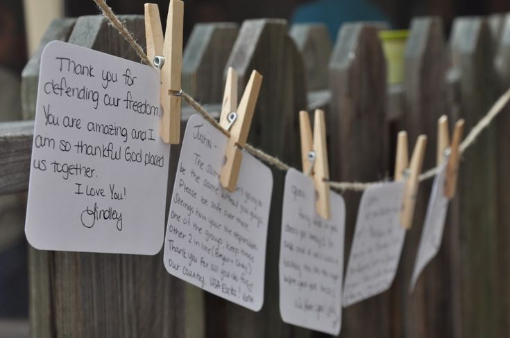 some clothes pins are hanging on a wooden fence with paper notes attached to them that say thank you so cherre