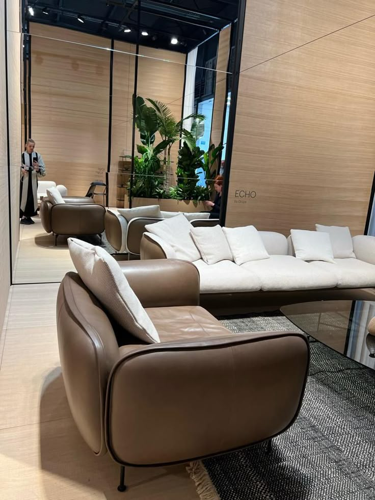 a living room with couches and chairs in it's display area at a furniture store