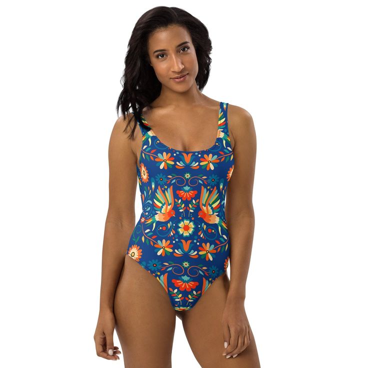 Inspired by the captivating artistry of Mexican Otomi designs, our One-Piece Swimsuit is a splash of culture for your beach days! Against a deep blue backdrop, the colorful design adds flair to your swimwear collection. Dive into style and make waves with every wear! This one-piece swimsuit for all figures will bring out your best features. Enjoy the smooth fabric and the flattering design, and show it off by the sea or pool! Blue Printed Swimwear For Pool, One-piece Printed Swimwear For Festivals, Blue Printed Swimwear For Beach Party, Blue Printed Swimwear For Beach, Blue Printed Swimwear For The Beach, Printed One-piece Swimwear For Festival, Blue Sleeveless Printed Bodysuit, Blue Printed Sleeveless Bodysuit, Blue Tropical Print Tankini For Pool