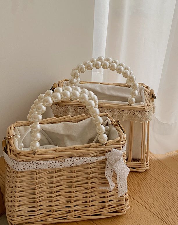 two wicker baskets with pearls on the handles