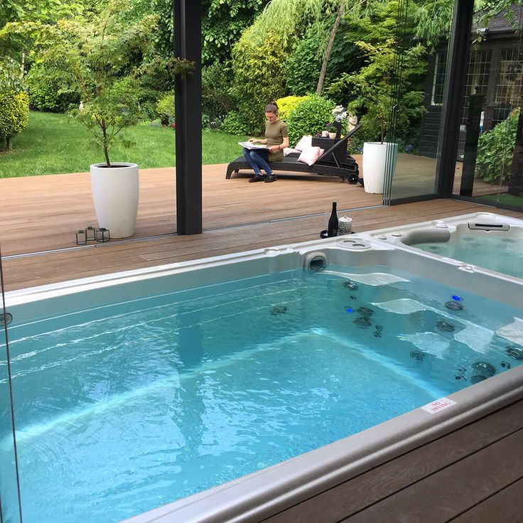 a large hot tub sitting on top of a wooden deck