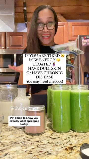 a woman holding up a sign in front of some green smoothies and yogurt