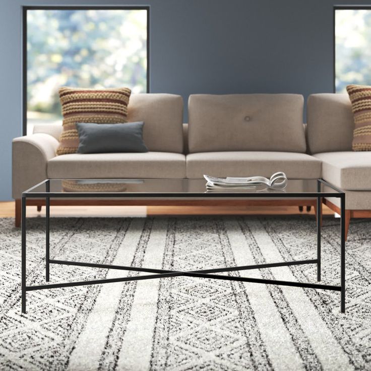 a living room scene with focus on the couch and coffee table in the foreground