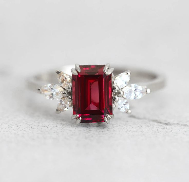 The Janine ring with gorgeous umba garnet and marquise white diamonds on the side, is truly a ring that will not go unnoticed. With it’s jaw dropping beautiful red color it is mesmerising and any lady would be happy to have this as her engagement ring. Details Center stone Gemstone: Natural Umba valley garnet Color: re Luxury Marquise Red Ruby Ring, Luxury Red Marquise Ruby Ring, Luxury Ruby Marquise Cut Rings, Marquise Red Diamond Ring, Luxury Marquise Cut Red Ruby Ring, Luxury Red Marquise Cut Ruby Ring, Red Ruby Ring With Marquise Cut Diamond, Red Marquise Cut Diamond Ring, Marquise Ruby Promise Ring With Prong Setting