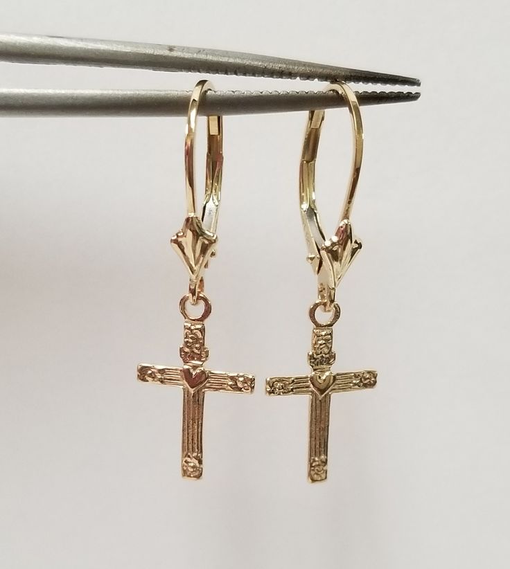 "Thanks for shopping our vintage estate store. We tend to sell well below wholesale and truly hope you enjoy all of our items. Many of the items are one of a kind, so please enjoy scrolling through the pictures and hopefully something will catch your eye. Brown spots are from camera or reflections. Nice estate New 14k yellow gold Victorian heart cross dangle earrings. Length: 1\" Width: 3/8\" Weight: 1.13 grams Beautiful earrings and make a sweet present for anyone. Marked 14k. Backs are include Classic Crucifix Jewelry For First Communion, Classic Gold Jewelry For Baptism, Classic 14k Gold Jewelry For First Communion, Classic Gold Jewelry For First Communion, Classic Yellow Gold Jewelry For First Communion, 14k Gold Cross Earrings, Classic 14k Gold Jewelry For Baptism, Classic Yellow Gold Jewelry For Baptism, Vintage 14k Gold Engraved Earrings